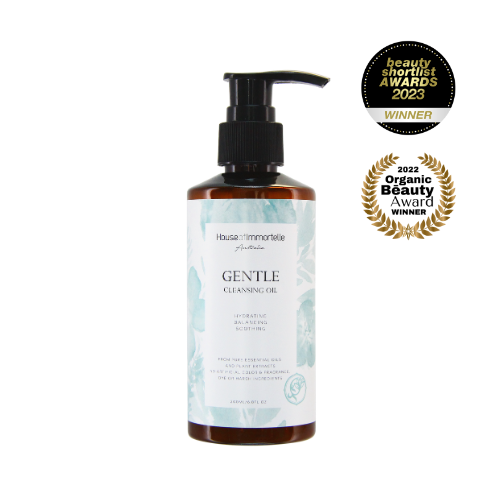 House of Immortelle Gentle Milky Cleanser in a smooth bottle, featuring a creamy formula designed to cleanse and hydrate the skin. This mild cleanser gently removes impurities while nourishing, leaving the skin soft, refreshed, and balanced