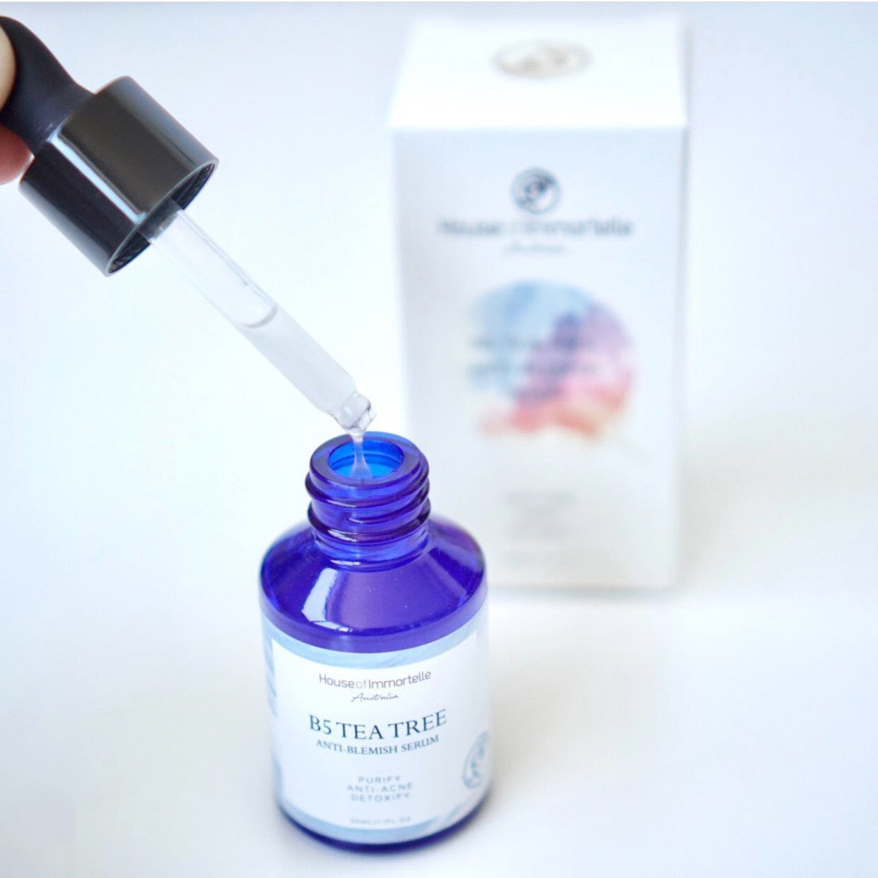 House of Immortelle B5 Tea Tree Anti-Blemish Serum in a sleek bottle, formulated with tea tree oil and vitamin B5 to target blemishes and soothe the skin. This lightweight serum helps reduce the appearance of acne and blemishes, leaving the skin clear and balanced