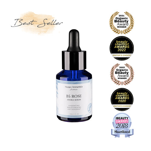 House of Immortelle B5 Rosr Hydra Serum bottle with a sleek design and dropper cap. The serum is designed to deeply hydrate and soothe the skin, enriched with Vitamin B5 and rose extracts for a refreshed and radiant complexion.