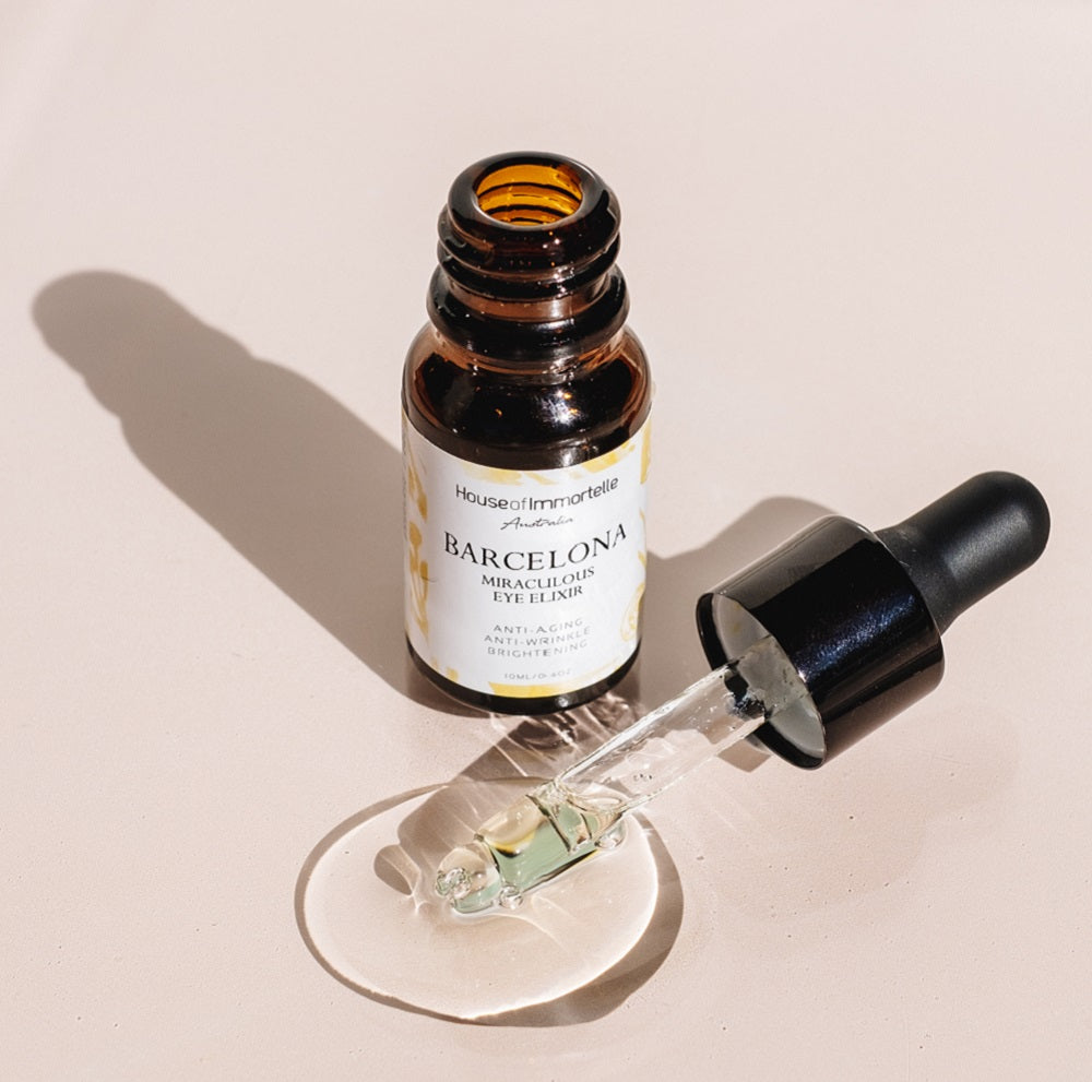 A rejuvenating Barcelona Miraculous Eye Elixir by House of Immortelle, formulated to reduce puffiness, dark circles, and fine lines around the delicate eye area. Its lightweight, soothing formula refreshes and revitalizes, leaving the eyes looking brighter and more youthful. Packaged in an elegant, travel-friendly bottle for daily use