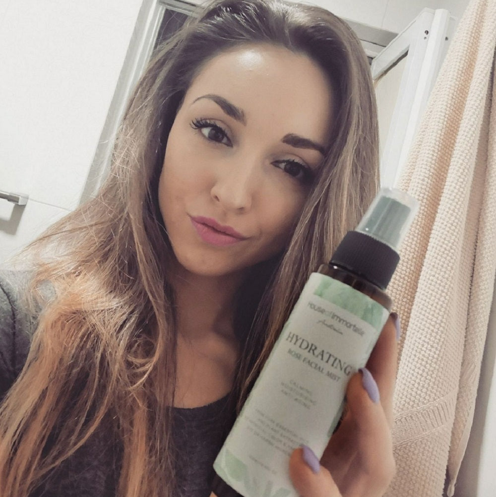 House of Immortelle Hydrating Rose Facial Mist in a sleek spray bottle, infused with rose extract to refresh and hydrate the skin. This mist provides a soothing, dewy glow, perfect for revitalizing the skin throughout the day or setting makeup