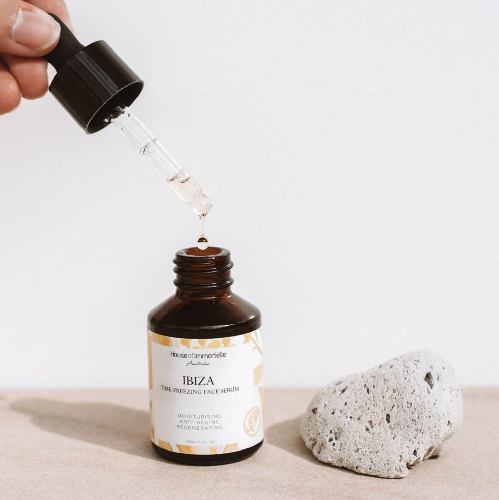 House of Immortelle Ibiza Time Freezing Face Serum in a sophisticated bottle, designed to reduce the appearance of fine lines and wrinkles. This lightweight serum is infused with potent anti-aging ingredients, providing a smooth, rejuvenated complexion for a youthful glow