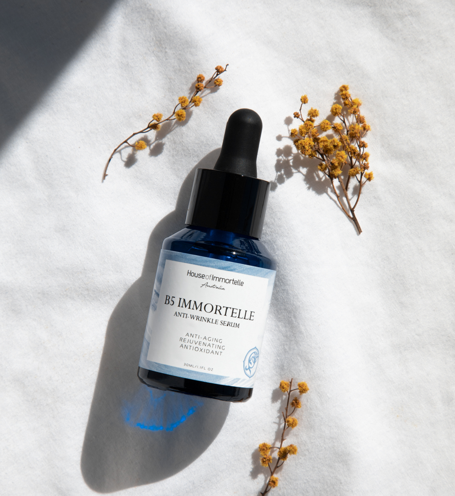 House of Immortelle B5 Immortelle Anti-Wrinkle Serum in an elegant bottle, enriched with Immortelle flower extract and vitamin B5 to reduce the appearance of fine lines and wrinkles. This lightweight serum helps to smooth, hydrate, and rejuvenate the skin for a more youthful complexion