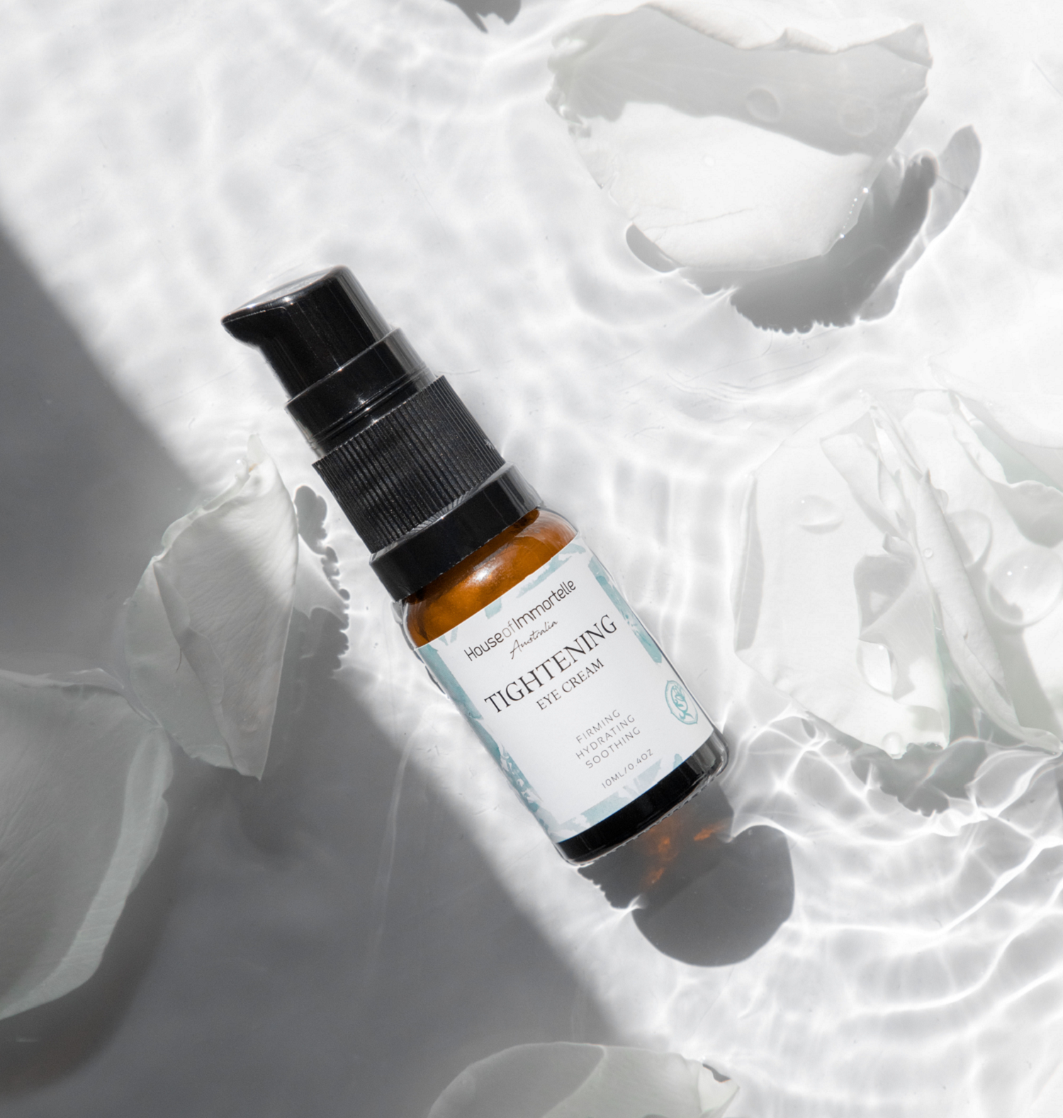 A potent Tightening Eye Cream by House of Immortelle, formulated to firm and smooth the delicate skin around the eyes. This rich cream helps reduce the appearance of fine lines, puffiness, and dark circles, leaving the eyes looking rejuvenated and refreshed. Packaged in a luxurious container for daily use.