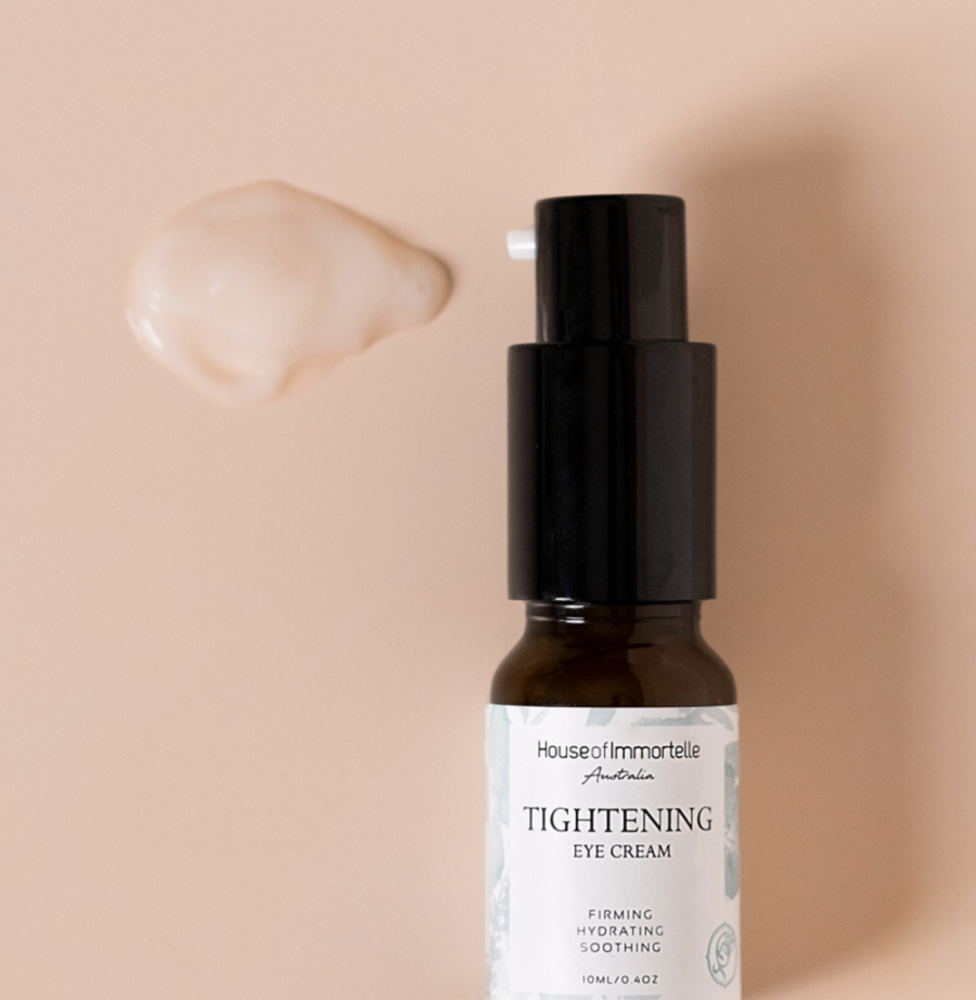 A potent Tightening Eye Cream by House of Immortelle, formulated to firm and smooth the delicate skin around the eyes. This rich cream helps reduce the appearance of fine lines, puffiness, and dark circles, leaving the eyes looking rejuvenated and refreshed. Packaged in a luxurious container for daily use.