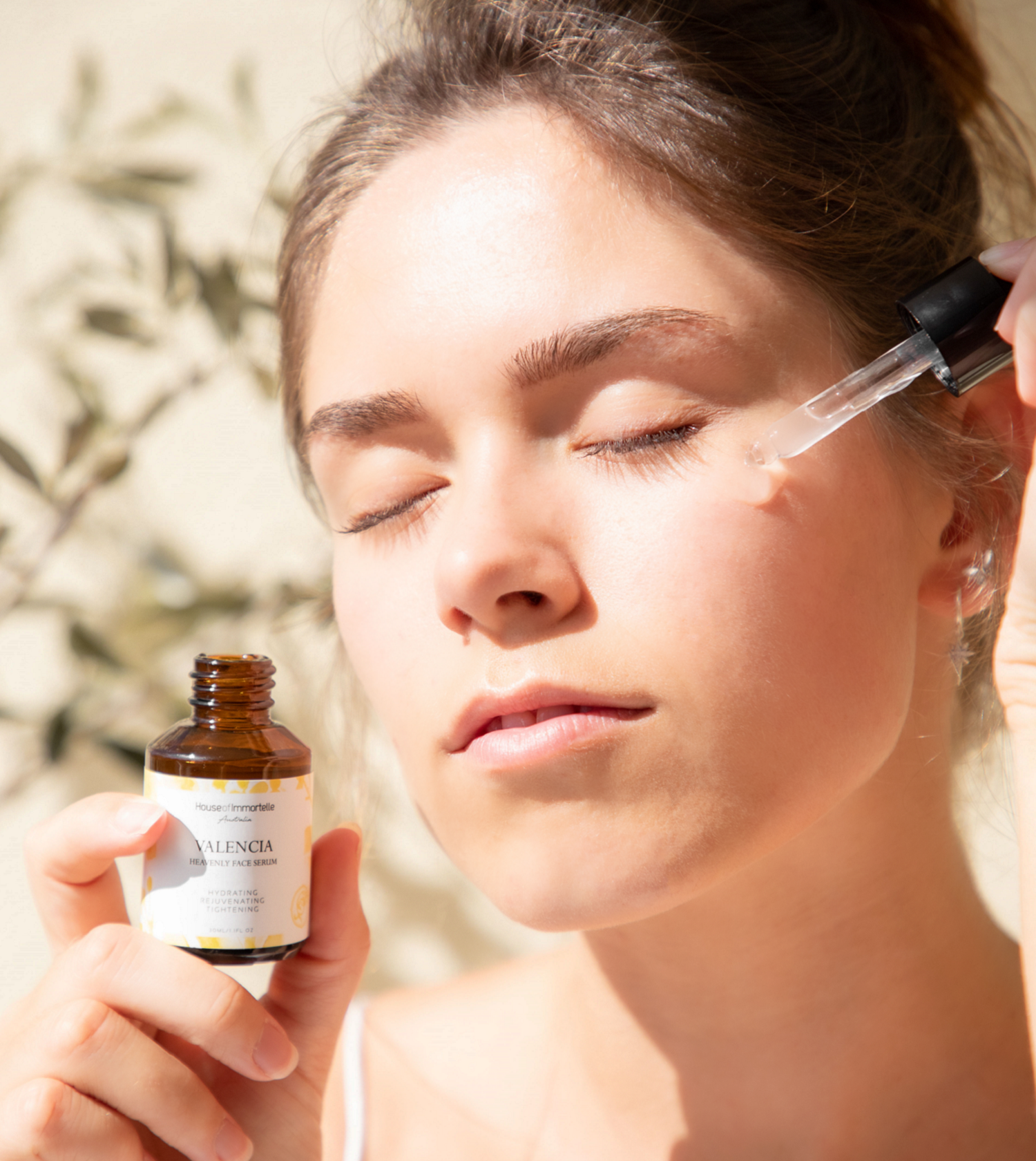 House of Immortelle Valencia Heavenly Face Serum in a sleek, elegant bottle, featuring a lightweight formula designed to hydrate and nourish the skin. The serum is infused with natural ingredients, offering a glowing, refreshed complexion, and is ideal for daily skincare routines