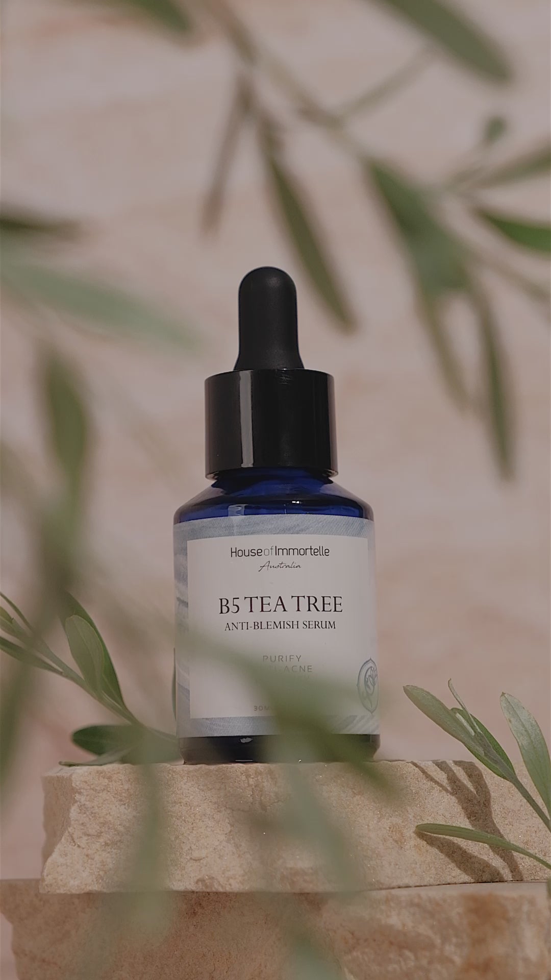 House of Immortelle B5 Tea Tree Anti-Blemish Serum in a sleek bottle, formulated with tea tree oil and vitamin B5 to target blemishes and soothe the skin. This lightweight serum helps reduce the appearance of acne and blemishes, leaving the skin clear and balanced