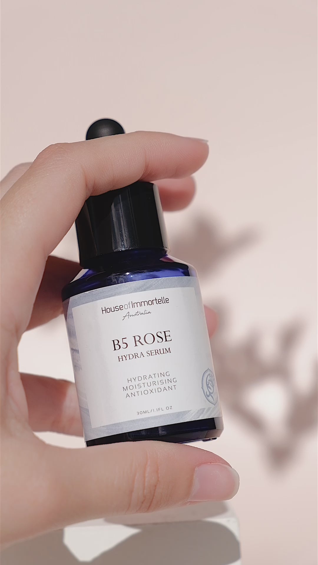 House of Immortelle B5 Rose Hydra Serum bottle with a sleek design and dropper cap. The serum is designed to deeply hydrate and soothe the skin, enriched with Vitamin B5 and rose extracts for a refreshed and radiant complexion.