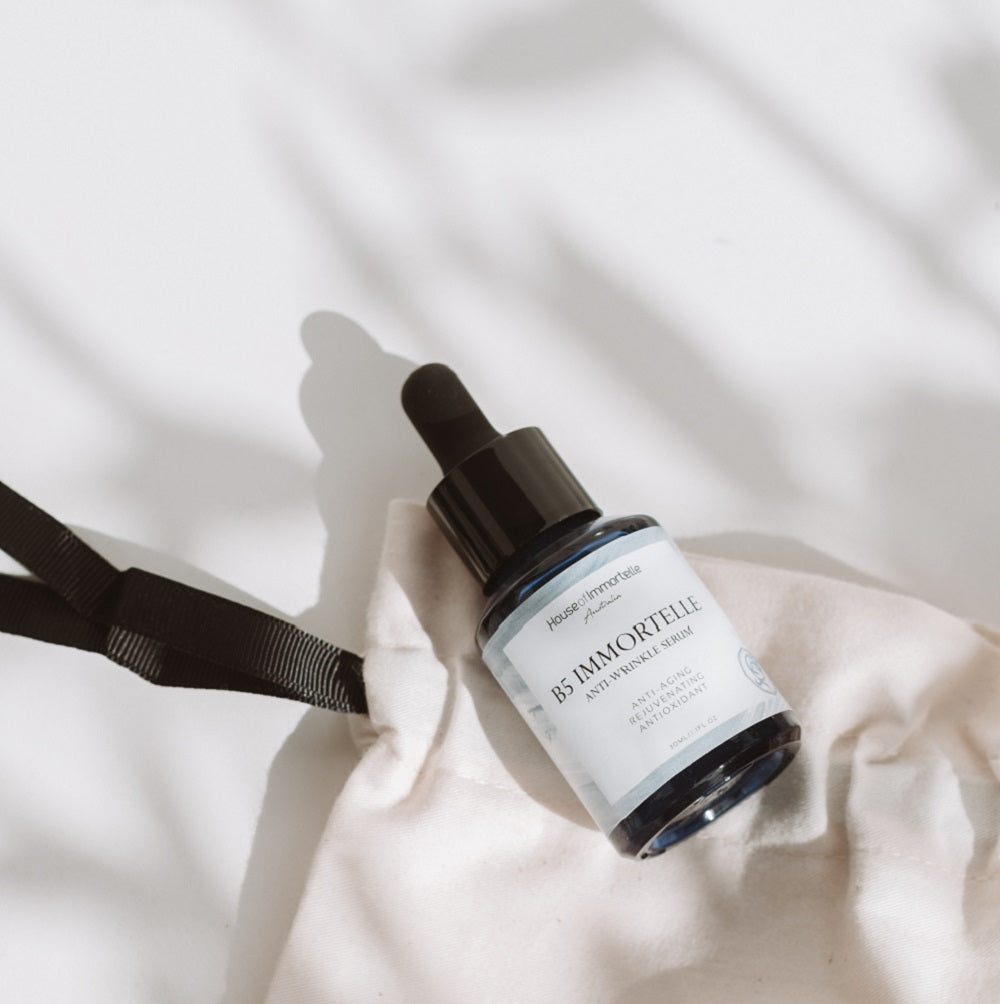 House of Immortelle B5 Immortelle Anti-Wrinkle Serum in an elegant bottle, enriched with Immortelle flower extract and vitamin B5 to reduce the appearance of fine lines and wrinkles. This lightweight serum helps to smooth, hydrate, and rejuvenate the skin for a more youthful complexion