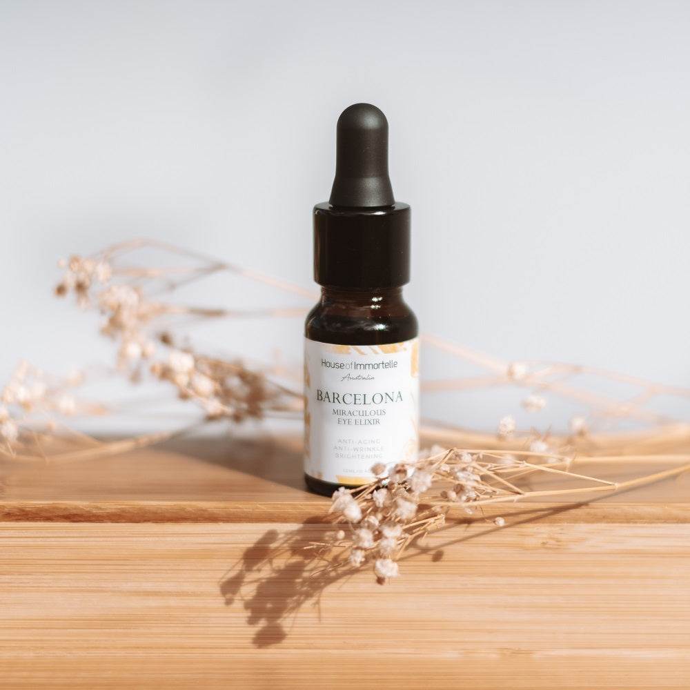 A rejuvenating Barcelona Miraculous Eye Elixir by House of Immortelle, formulated to reduce puffiness, dark circles, and fine lines around the delicate eye area. Its lightweight, soothing formula refreshes and revitalizes, leaving the eyes looking brighter and more youthful. Packaged in an elegant, travel-friendly bottle for daily use