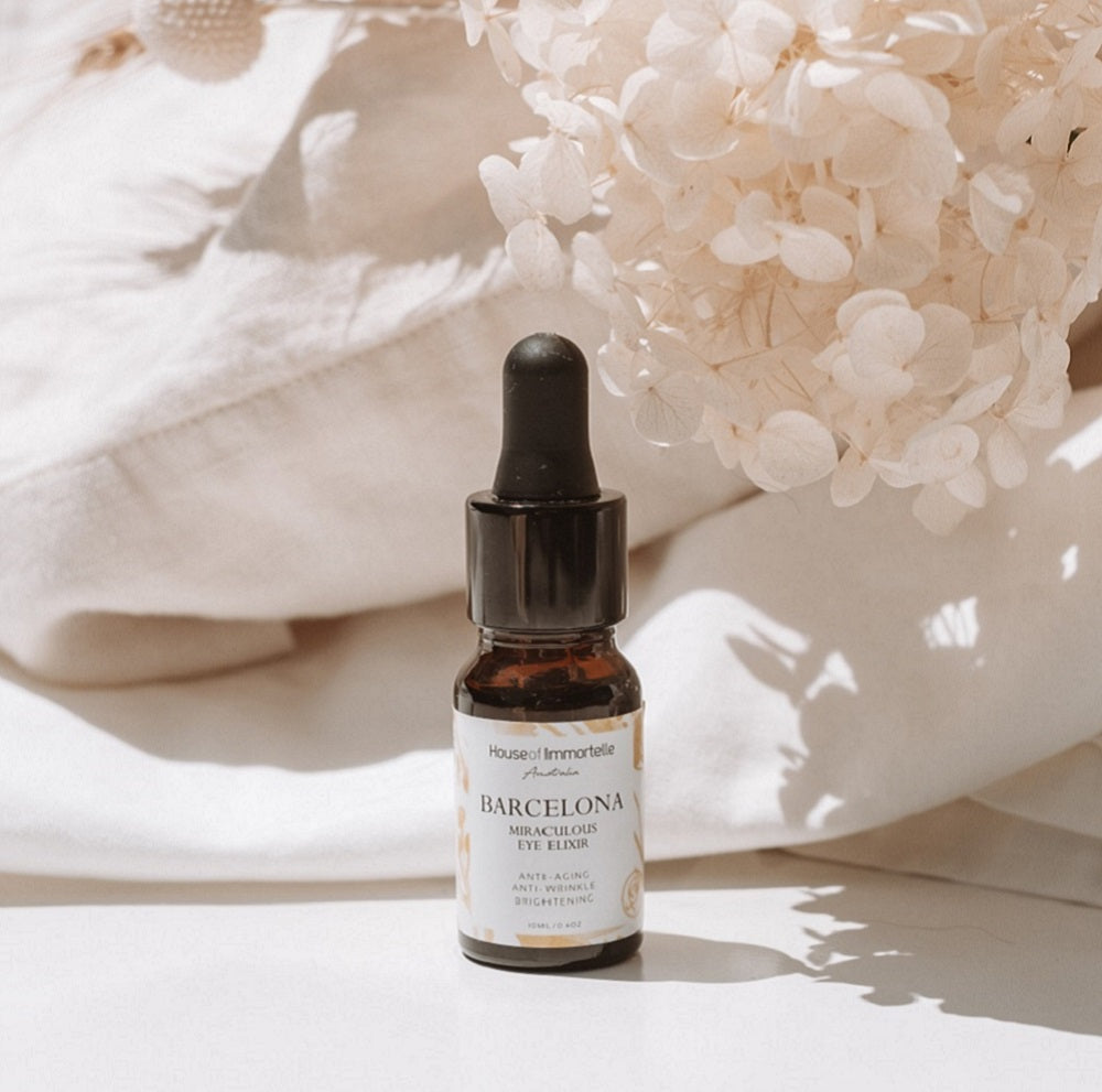 A rejuvenating Barcelona Miraculous Eye Elixir by House of Immortelle, formulated to reduce puffiness, dark circles, and fine lines around the delicate eye area. Its lightweight, soothing formula refreshes and revitalizes, leaving the eyes looking brighter and more youthful. Packaged in an elegant, travel-friendly bottle for daily use