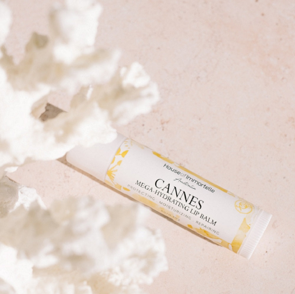 A nourishing Cannes Mega Hydrating Lip Balm by House of Immortelle, designed to deeply hydrate and protect the lips. Its rich formula provides long-lasting moisture, leaving lips soft, smooth, and supple. The sleek, portable packaging makes it perfect for on-the-go hydration