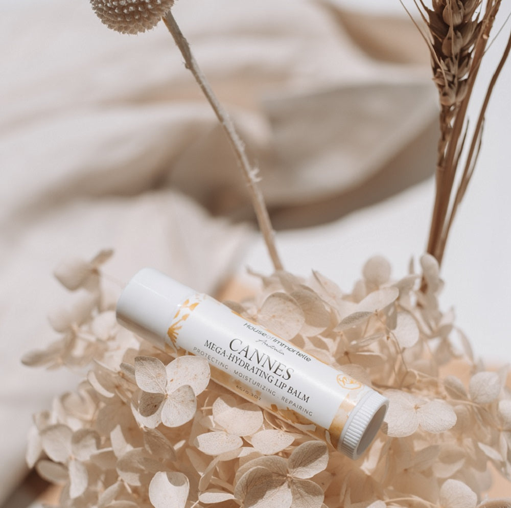 A nourishing Cannes Mega Hydrating Lip Balm by House of Immortelle, designed to deeply hydrate and protect the lips. Its rich formula provides long-lasting moisture, leaving lips soft, smooth, and supple. The sleek, portable packaging makes it perfect for on-the-go hydration
