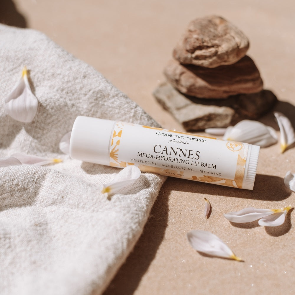 A nourishing Cannes Mega Hydrating Lip Balm by House of Immortelle, designed to deeply hydrate and protect the lips. Its rich formula provides long-lasting moisture, leaving lips soft, smooth, and supple. The sleek, portable packaging makes it perfect for on-the-go hydration