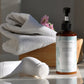 House of Immortelle Gentle Milky Cleanser in a smooth bottle, featuring a creamy formula designed to cleanse and hydrate the skin. This mild cleanser gently removes impurities while nourishing, leaving the skin soft, refreshed, and balanced