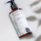 House of Immortelle Gentle Milky Cleanser in a smooth bottle, featuring a creamy formula designed to cleanse and hydrate the skin. This mild cleanser gently removes impurities while nourishing, leaving the skin soft, refreshed, and balanced