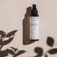 House of Immortelle Refreshing Rosemary Facial Mist in a sleek spray bottle, formulated with rosemary extract to invigorate and tone the skin. This mist offers an energizing refresh, perfect for hydrating and rejuvenating the skin throughout the day.