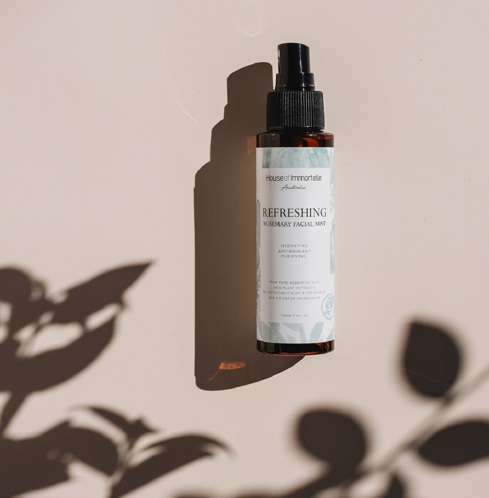 House of Immortelle Refreshing Rosemary Facial Mist in a sleek spray bottle, formulated with rosemary extract to invigorate and tone the skin. This mist offers an energizing refresh, perfect for hydrating and rejuvenating the skin throughout the day.