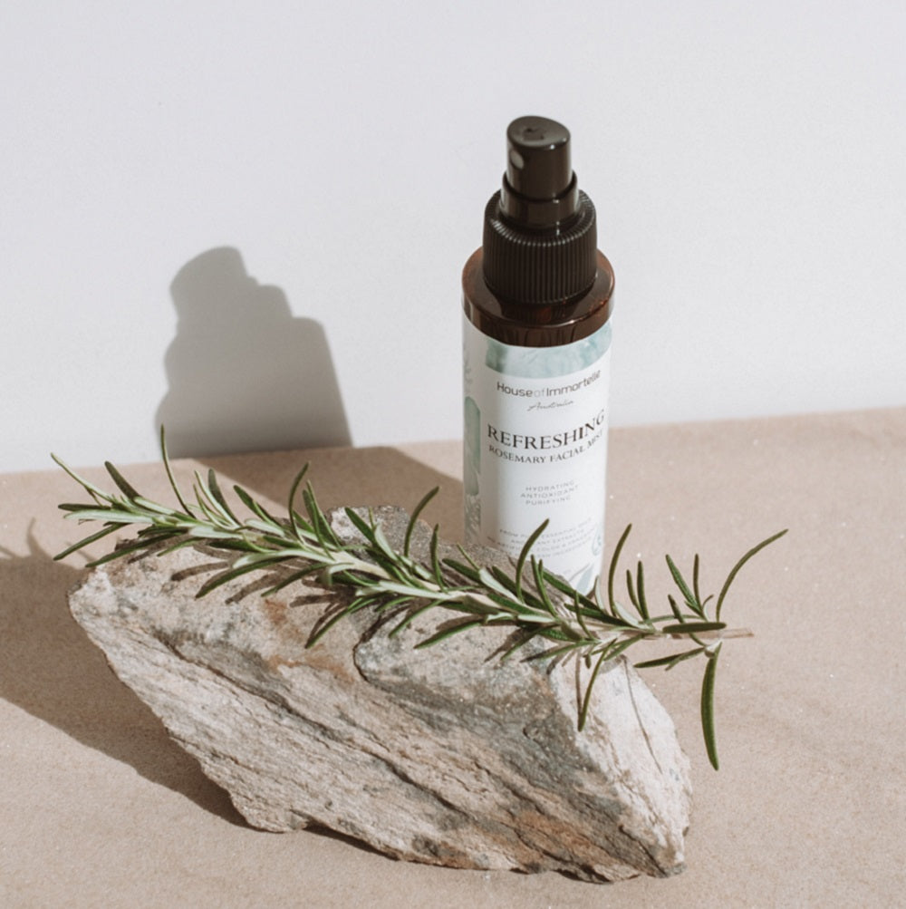 House of Immortelle Refreshing Rosemary Facial Mist in a sleek spray bottle, formulated with rosemary extract to invigorate and tone the skin. This mist offers an energizing refresh, perfect for hydrating and rejuvenating the skin throughout the day.