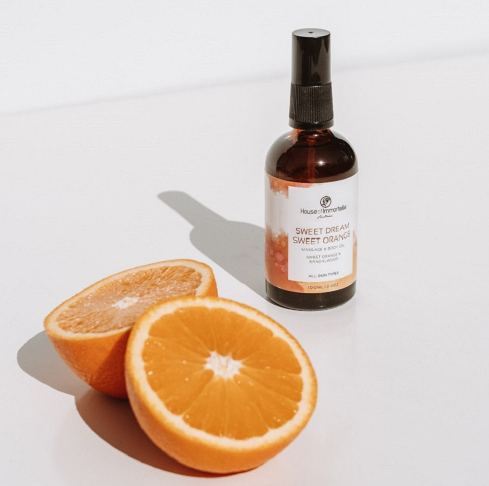 House of Immortelle Sweet Dream Sweet Orange Body Oil in an elegant bottle, infused with a refreshing sweet orange scent. The body oil is designed to hydrate and nourish the skin, with a smooth texture and a minimalist label highlighting its natural, calming ingredients.