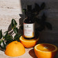 House of Immortelle Sweet Dream Sweet Orange Body Oil in an elegant bottle, infused with a refreshing sweet orange scent. The body oil is designed to hydrate and nourish the skin, with a smooth texture and a minimalist label highlighting its natural, calming ingredients.