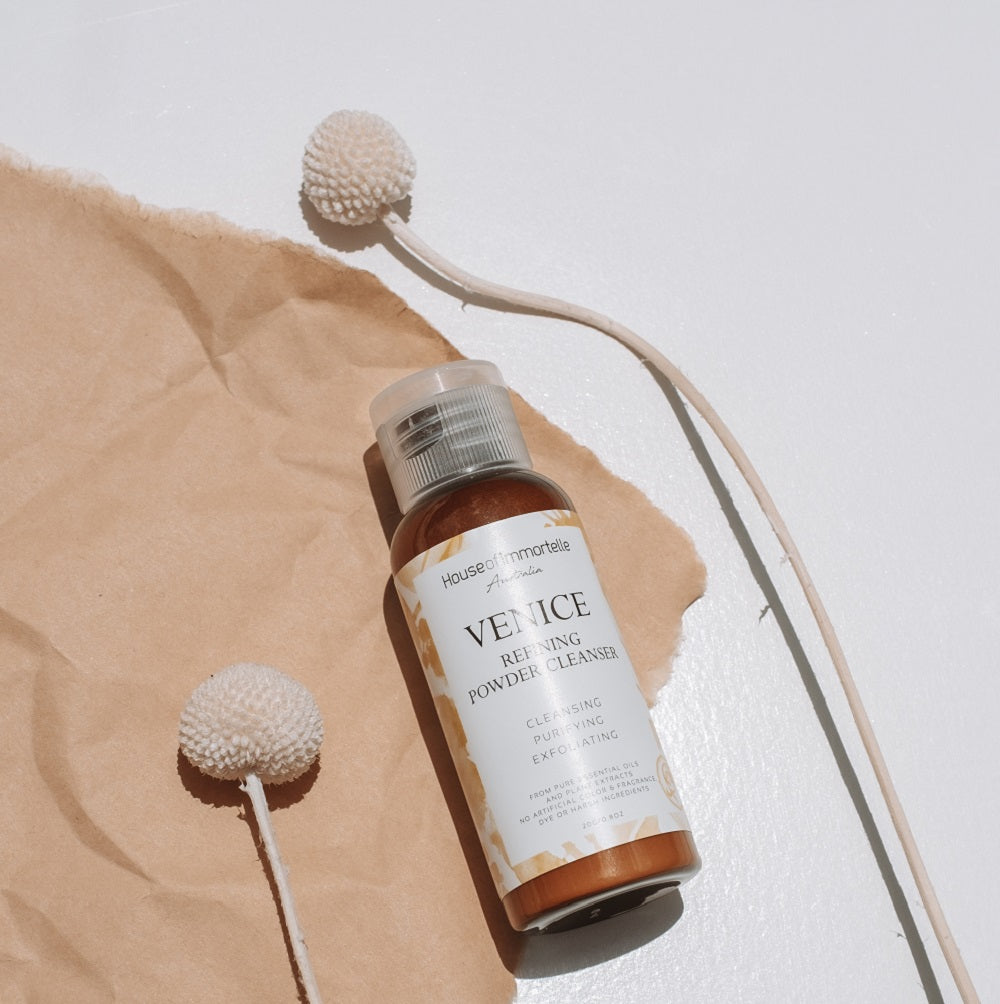 A refined Venice Refining Powder Cleanser by House of Immortelle, a gentle yet effective formula that transforms into a soft foam when mixed with water. This powder cleanser exfoliates and purifies the skin, leaving it smooth, bright, and refreshed. The elegant packaging makes it perfect for a luxurious skincare routine