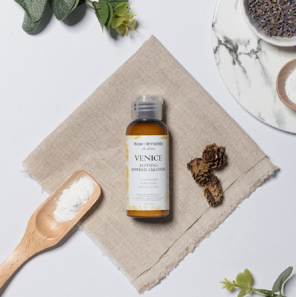 A refined Venice Refining Powder Cleanser by House of Immortelle, a gentle yet effective formula that transforms into a soft foam when mixed with water. This powder cleanser exfoliates and purifies the skin, leaving it smooth, bright, and refreshed. The elegant packaging makes it perfect for a luxurious skincare routine