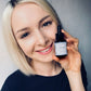 Model applying House of Immortelle B5 Rose Hydra Serum for deep hydration and healthy-looking skin.